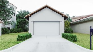 A standalone garage painted white sits at the end of a driveway.