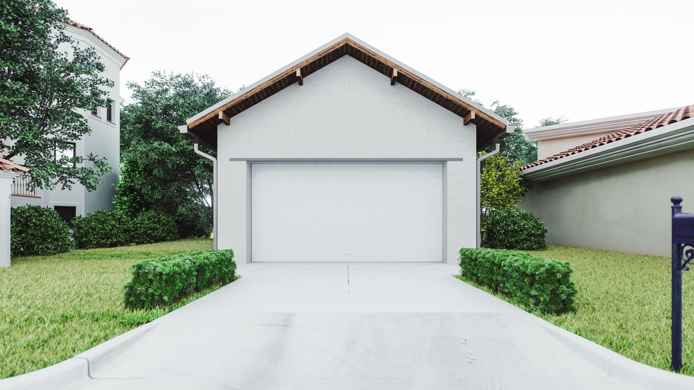 A standalone garage painted white sits at the end of a driveway. 