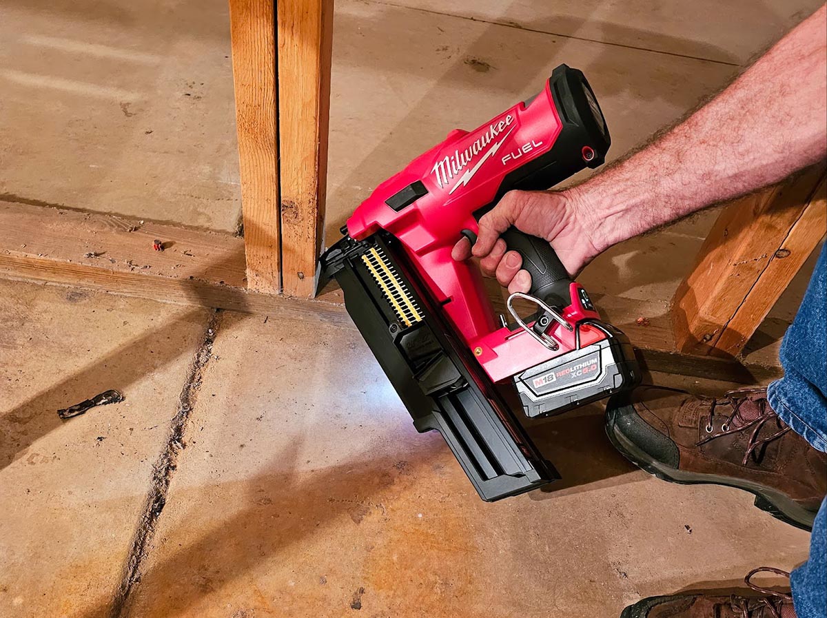 A person using the best cordless framing nailer option to install framing