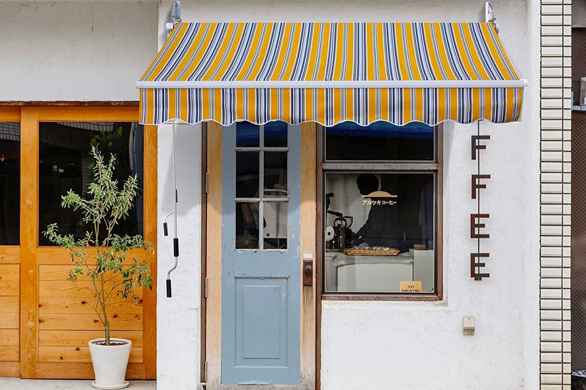 The Best Retractable Awnings Option extending over the front door and window of a coffee shop