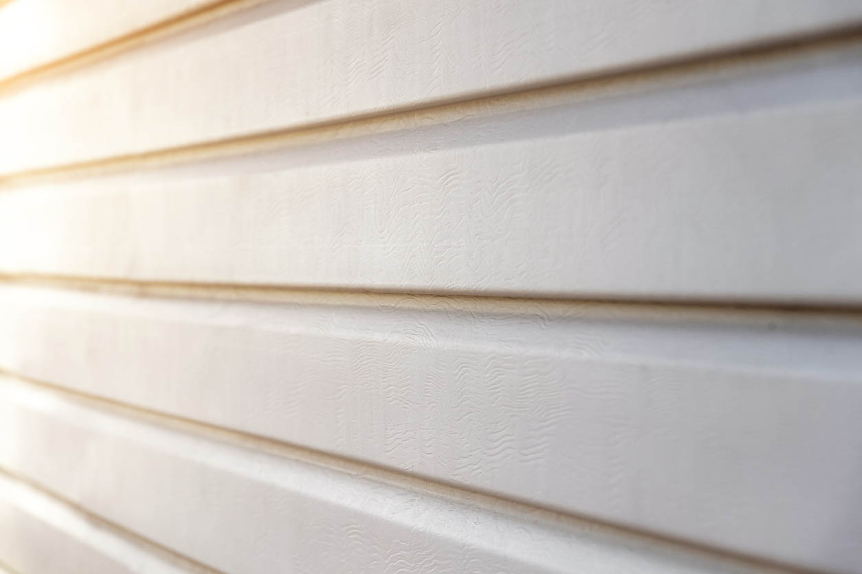 A close up of beige vinyl siding.