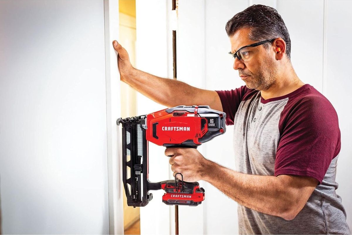 A person using the best cordless finish nailer on a door frame