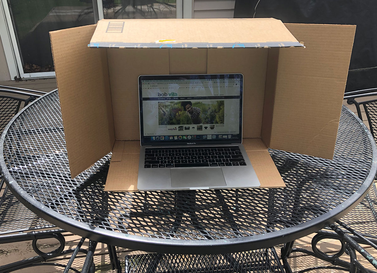 using cardboard box to shade computer glare when working outside