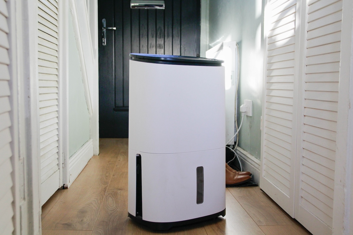 Dehumidifier stands in a sunny hallway.
