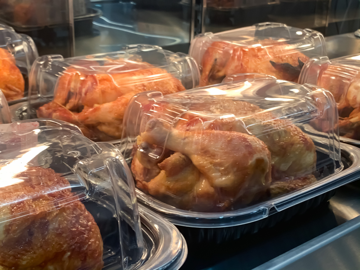 Packed roast chicken place on the shelf waiting to sale in the market deli section