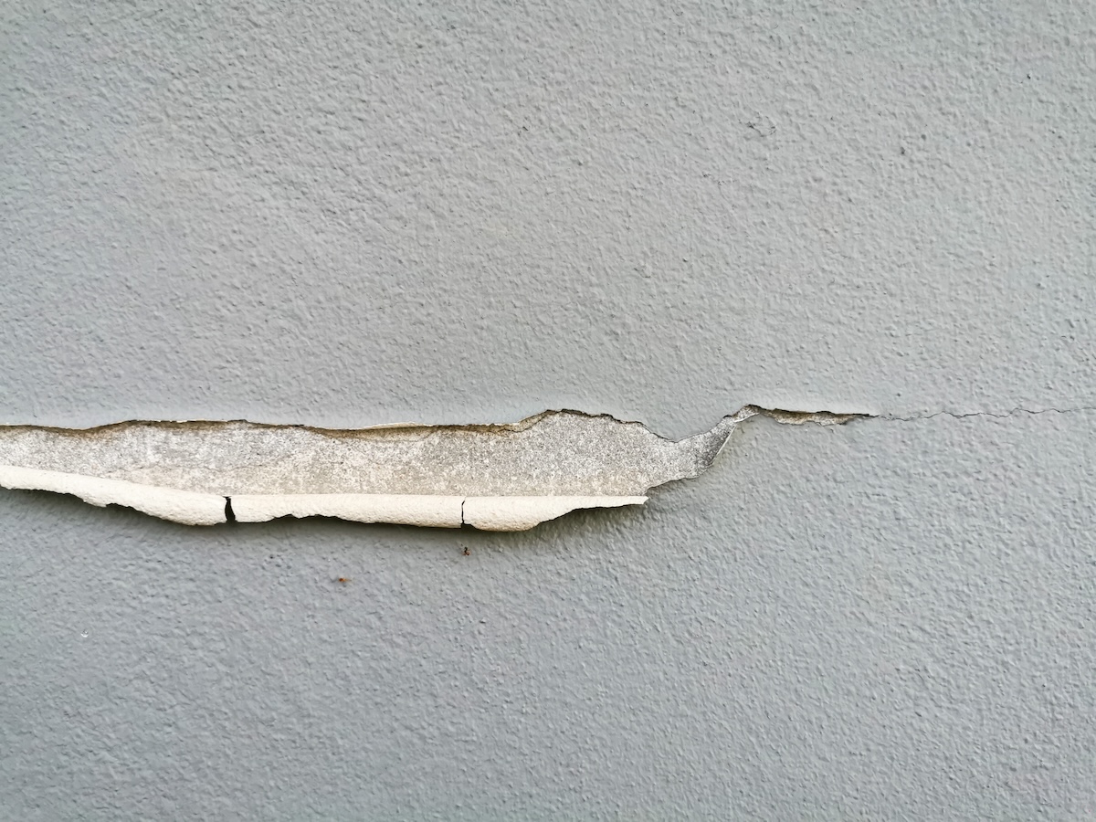 White paint peeling away from the wall.