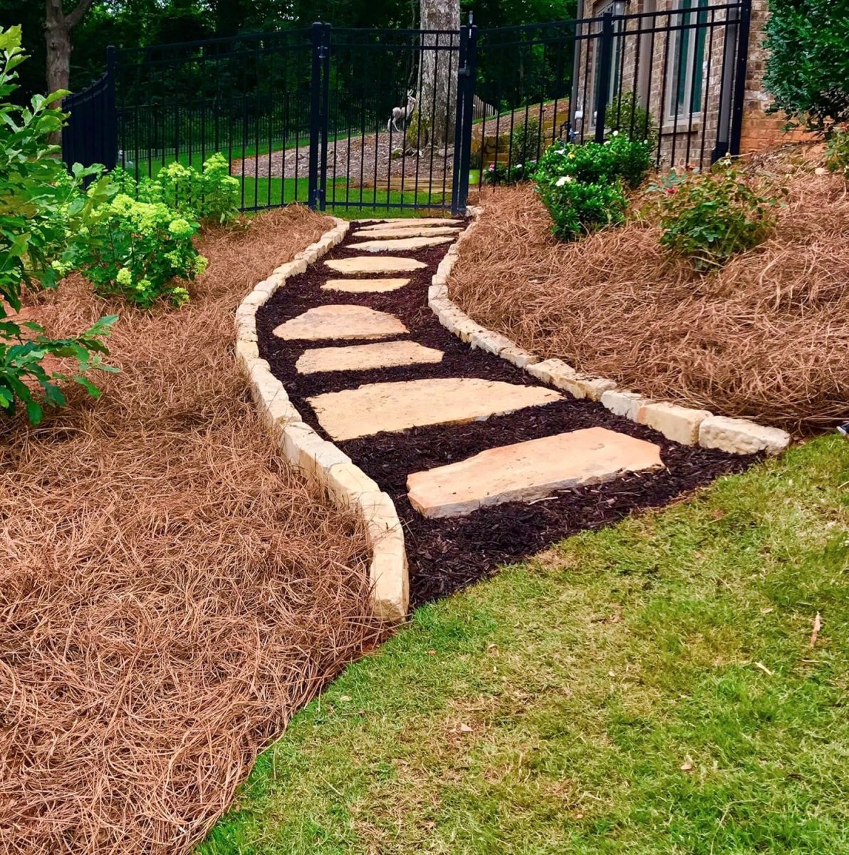 Lovely mulch and stone pathway bordered by pine straw mulch.