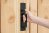 A person with their hand on the best gate latch option