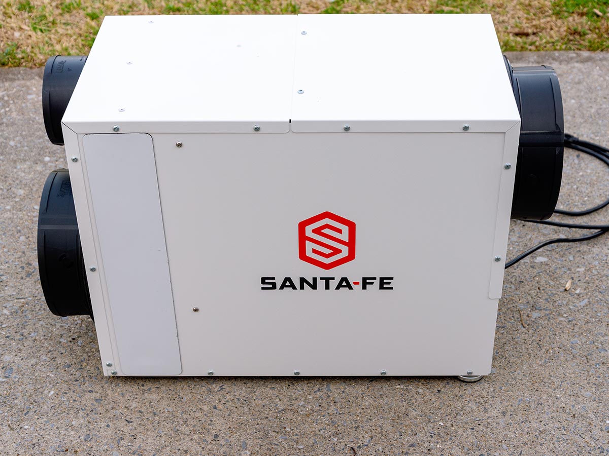 The Santa Fe Ultra98 Whole-House Ventilating Dehumidifier on a cement pad before installation and testing.