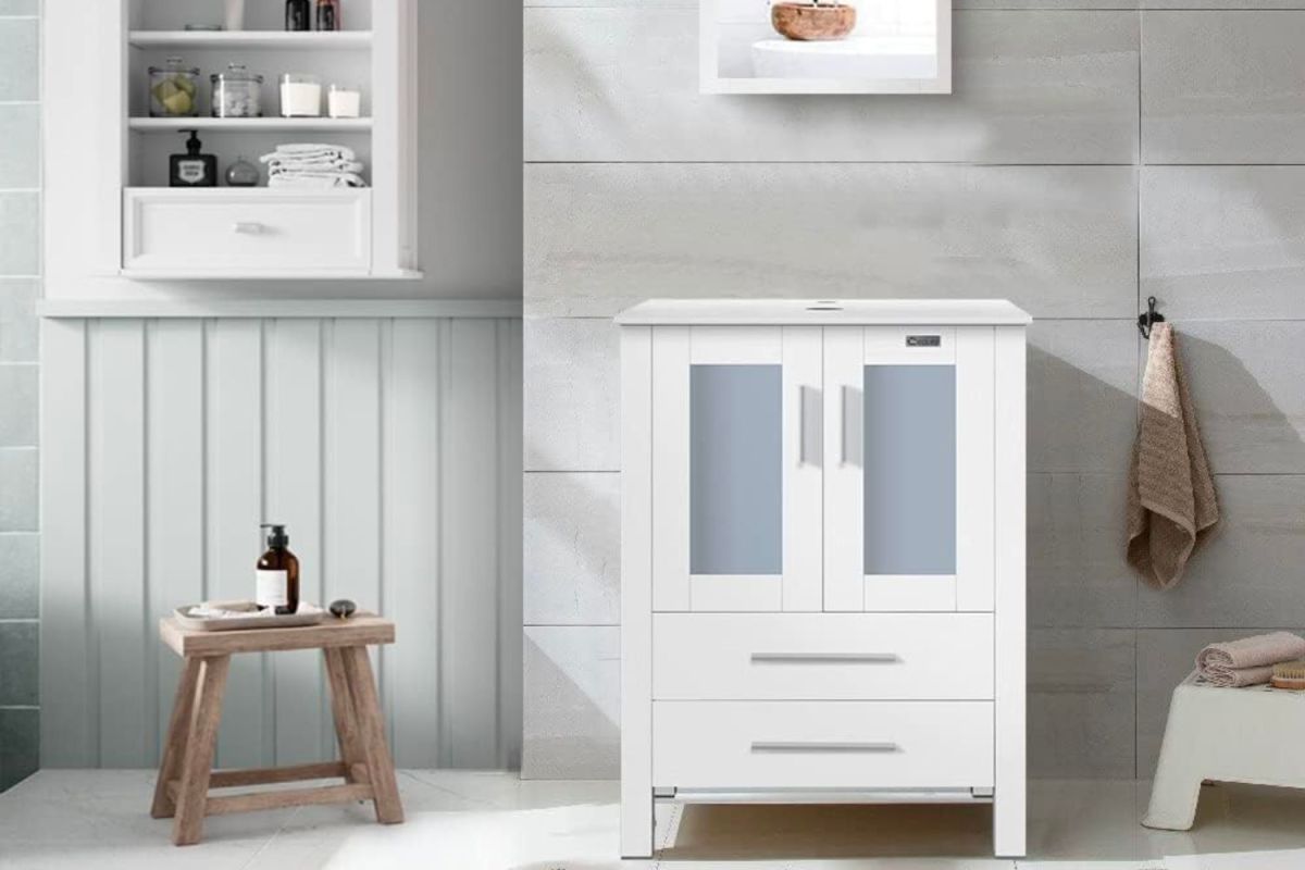 The Water Creation Madison 30-Inch Modern White Vanity in a grey bathroom with a small wooden stool next to it.