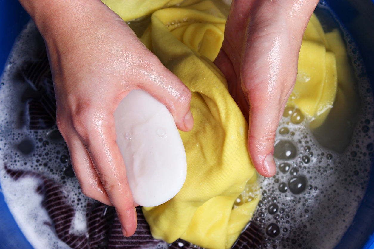 A woman washes clothes with her hands in soapy water. Hand wash clothes. High quality photo