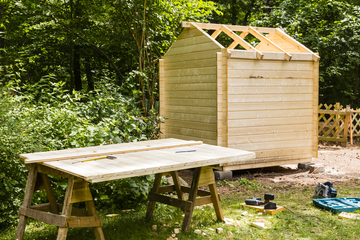 Construction of a wooden hut in a garden