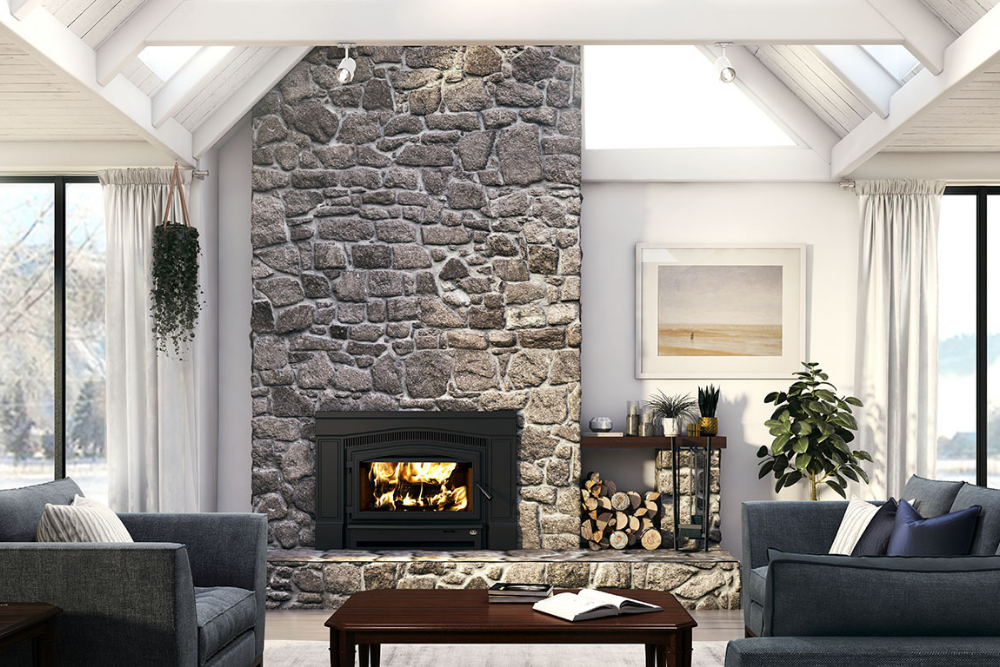 The best wood-burning fireplace inserts option set in a large stone chimney in a spacious living room