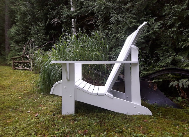Side view of low-profile white Adirondack chair