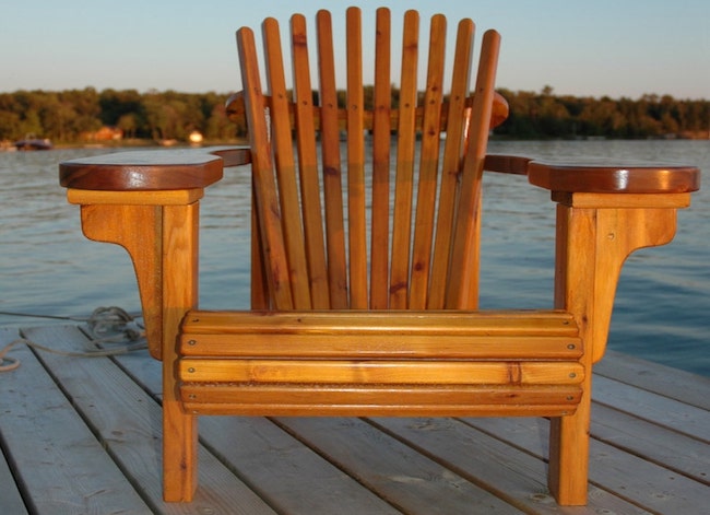Adirondack chair with wide arms on a deck by the lake