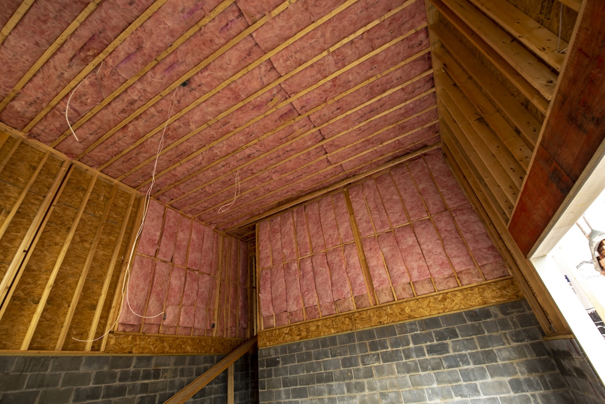 A home with pink unfaced insulation installed.
