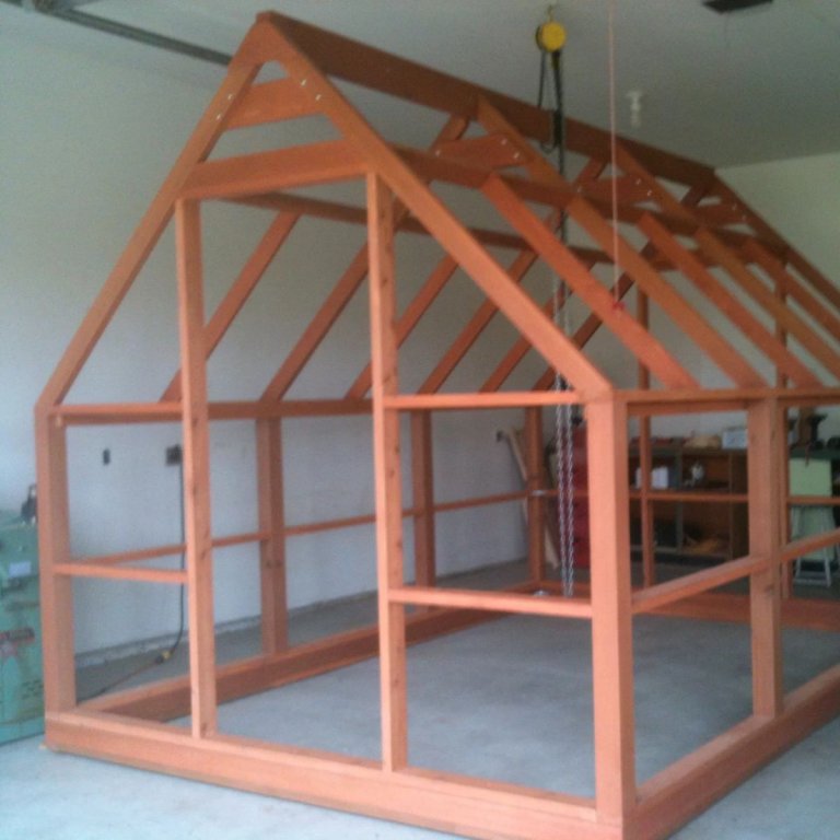 Partially built DIY Cedar Greenhouse Plans (design by SunCountryWoodCrafts) in a garage workshop