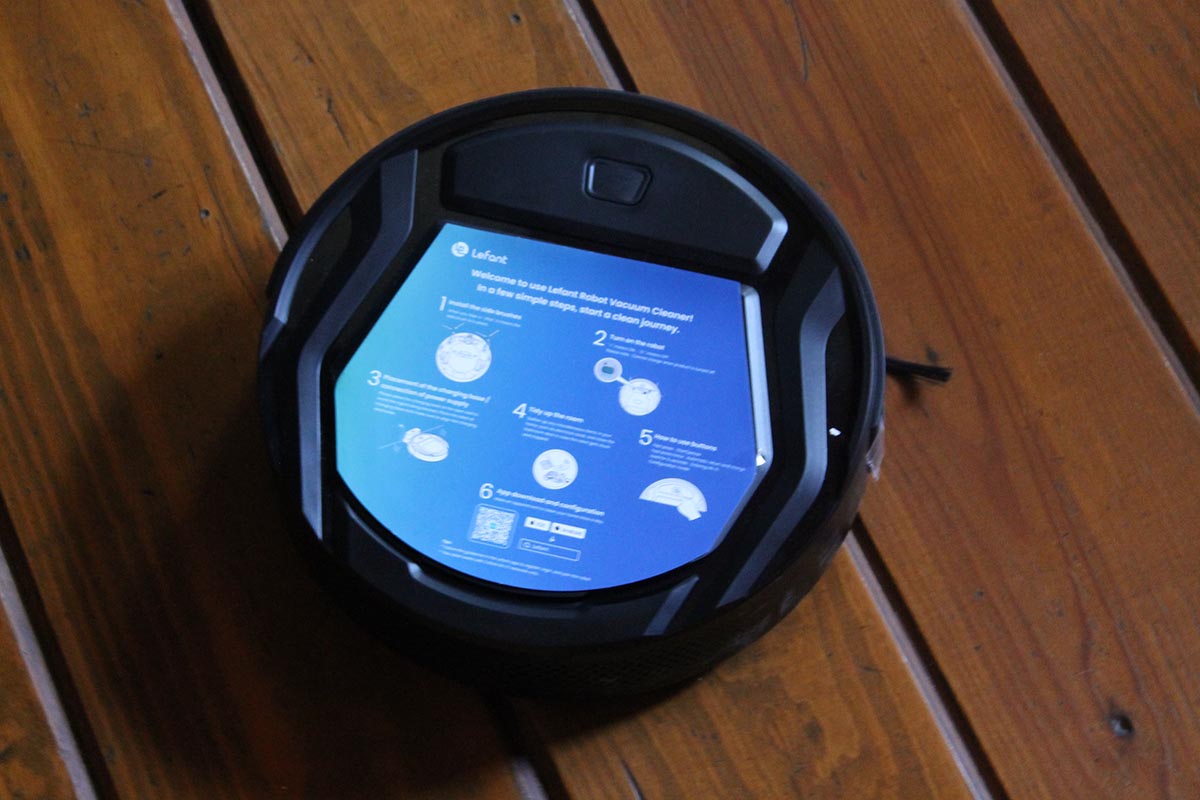 The Best Robot Vacuum for Hardwood Floors with its large blue control screen lit up.