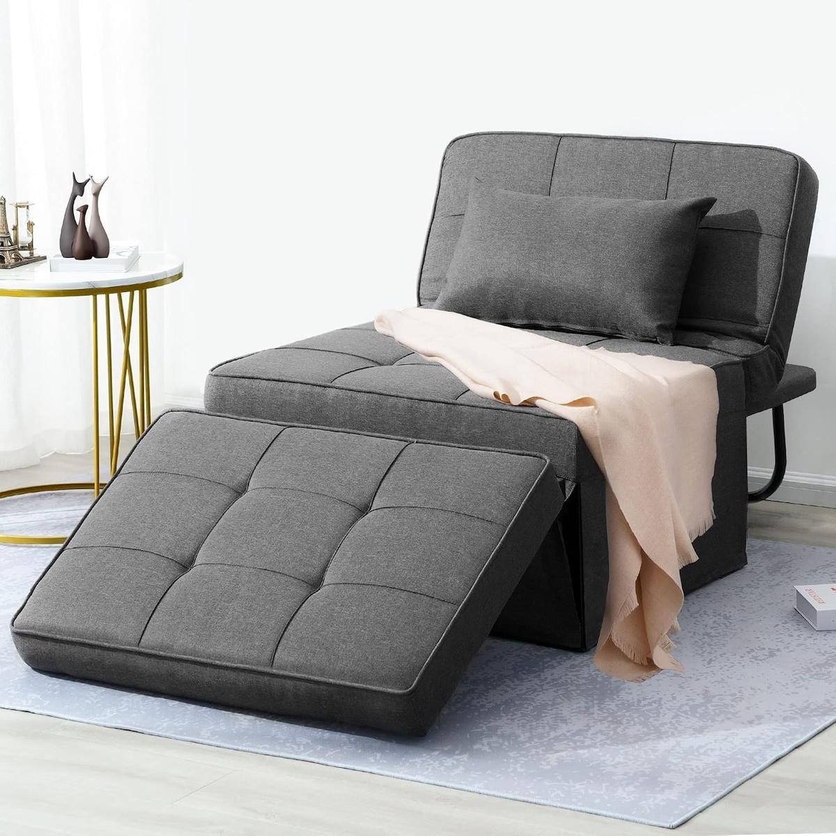 Grey BIGSYY sofa bed 4-in-1 in a living room with a throw blanket on it.