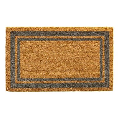 Brown coir doormat with black border on white background