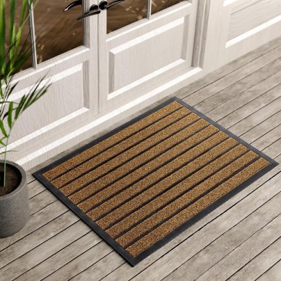 Brown and black doormat on gray wood porch