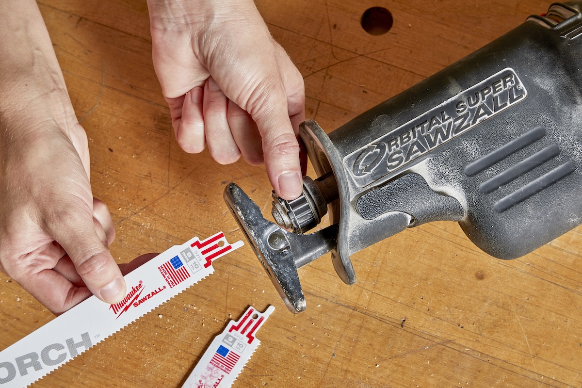 Woman replaces blades on a Sawzall.