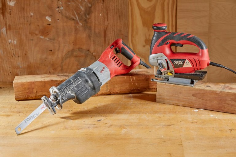 Jigsaw and reciprocating saw propped on 2 x 4s.