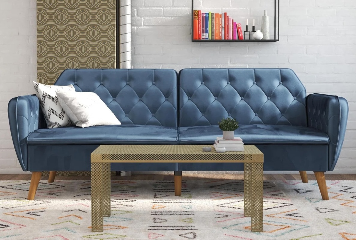 Novogratz Talulah blue velvet couch with throw pillows.