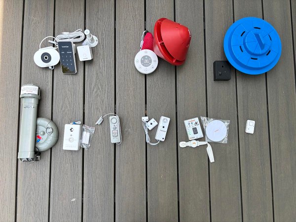 A group of the best pool alarms on a pool deck before testing.