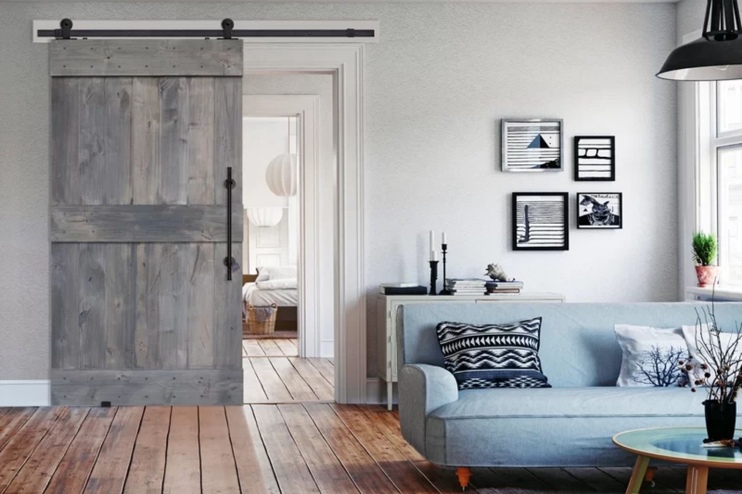 The best barn door option open partway to reveal a bedroom just off a living room