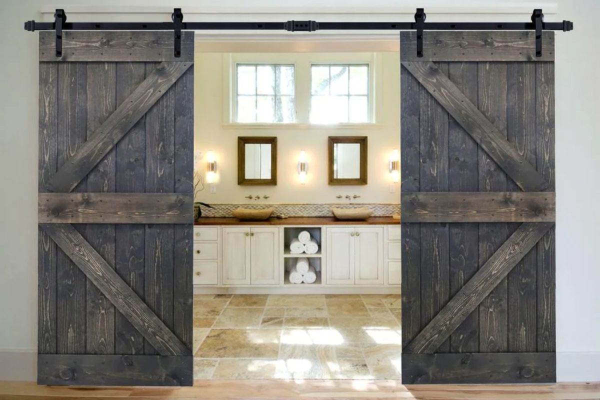 A set of the best barn door options partially open leading into a very large bathroom