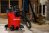 A large red wet and dry shop vac being used in the basement.