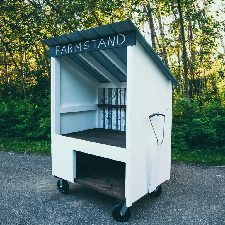 DIY Farmstand Plans built on wheels at the end of a driveway
