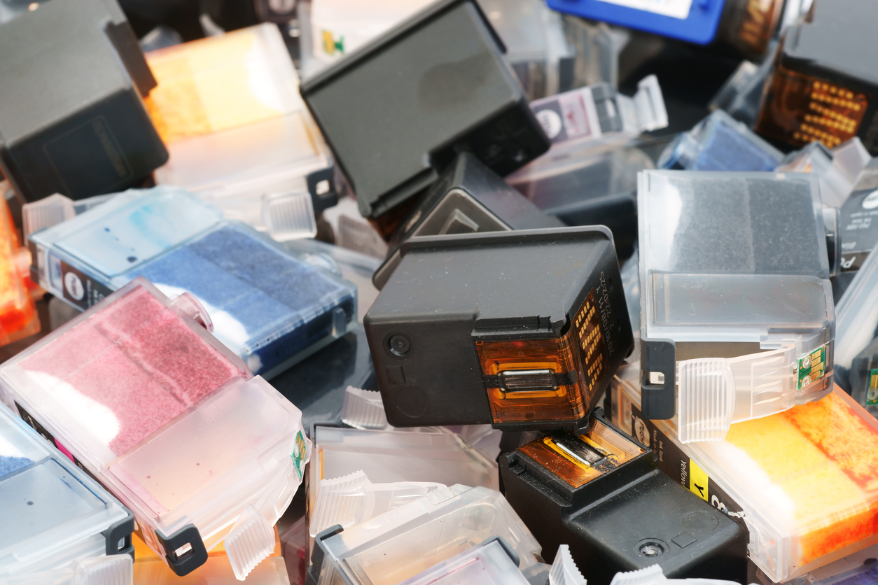 A pile of used ink cartridges ready to be recycled.