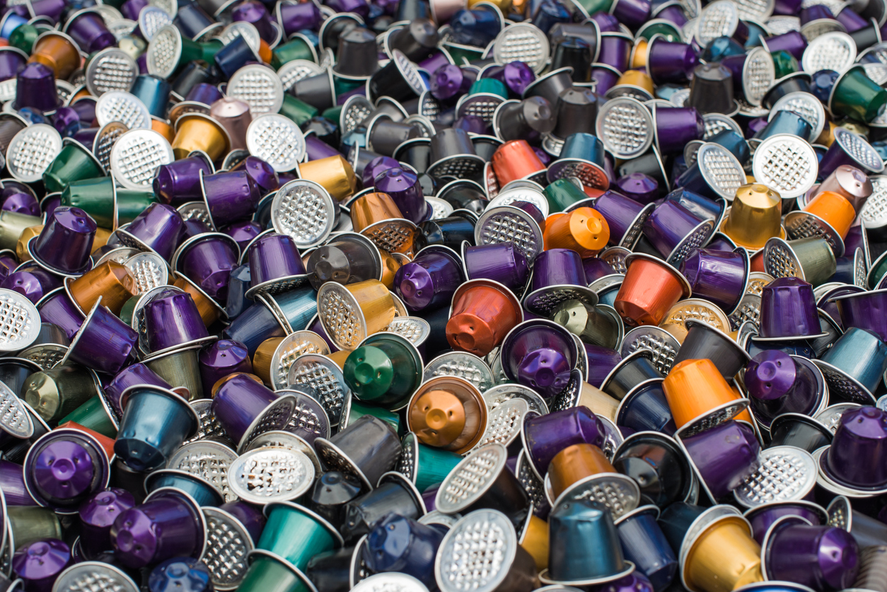 overhead close view of a pile of different colored used Nespresso pods.