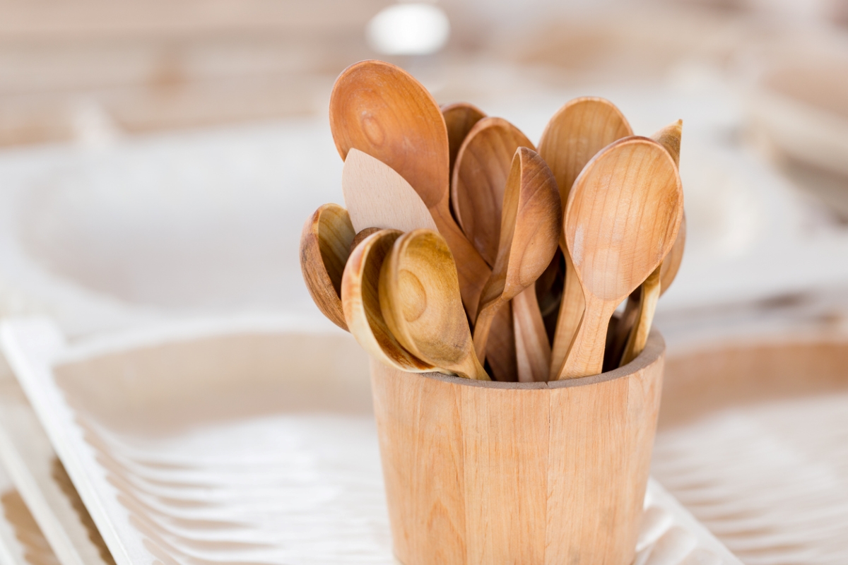Close up of wooden kitchen utensils in wooden holder.