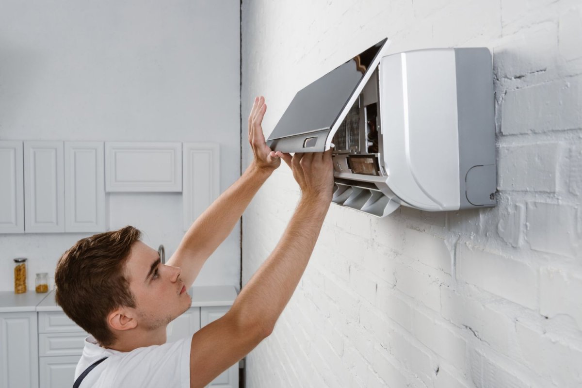 Person opening the cover of one of the the Best Energy Efficient Air Conditioners