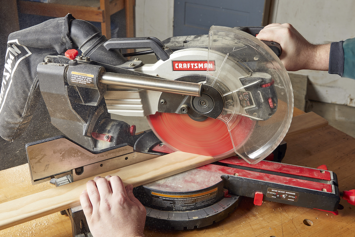 Cutting wood with a miter saw.