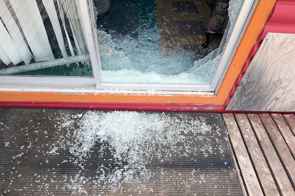 A glass sliding door that has been shattered. 