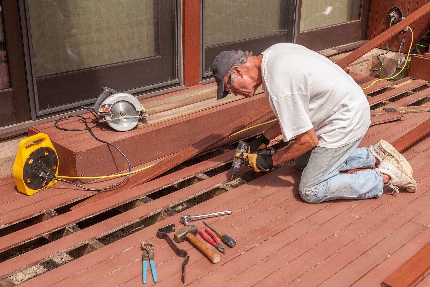 A worker used a power tool to repair a deck.