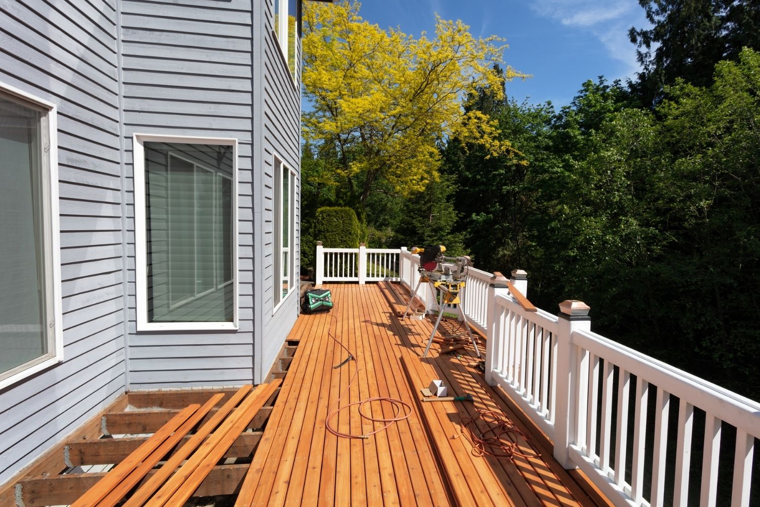 A deck is being repaired on a sunny day.