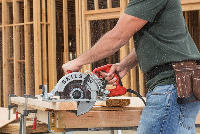 Man using a circular saw at a job site.