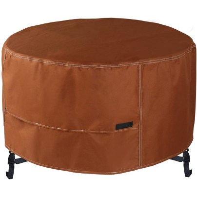 The NettyPro Outdoor Round Fire Pit Cover covering a fire pit on a white background.