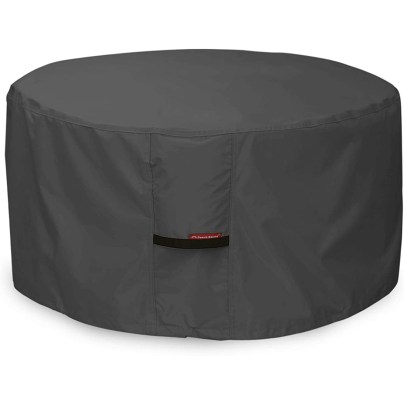 The Porch Shield Waterproof Fire Pit Cover covering a fire pit on a white background.
