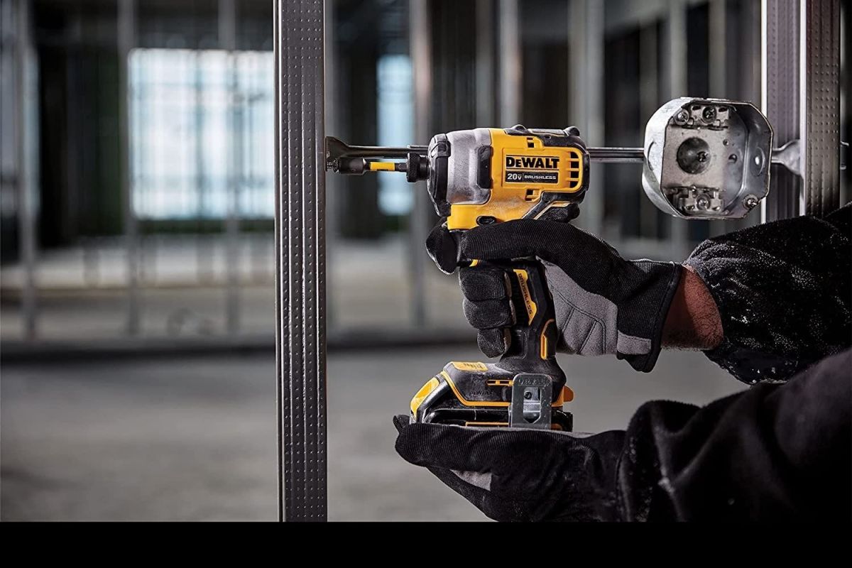 A person using the Best DeWalt Impact Driver on metal framing.