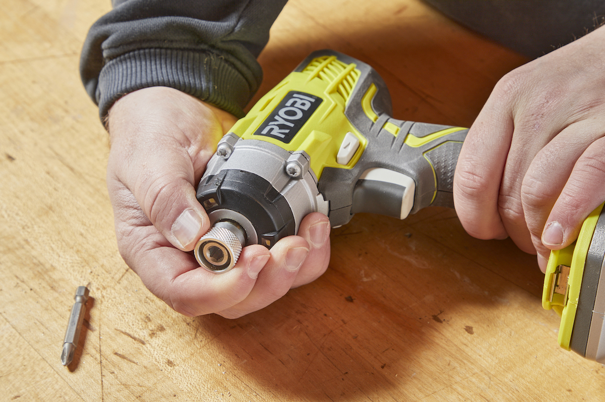 Preparing to change a drill bit on an impact driver.
