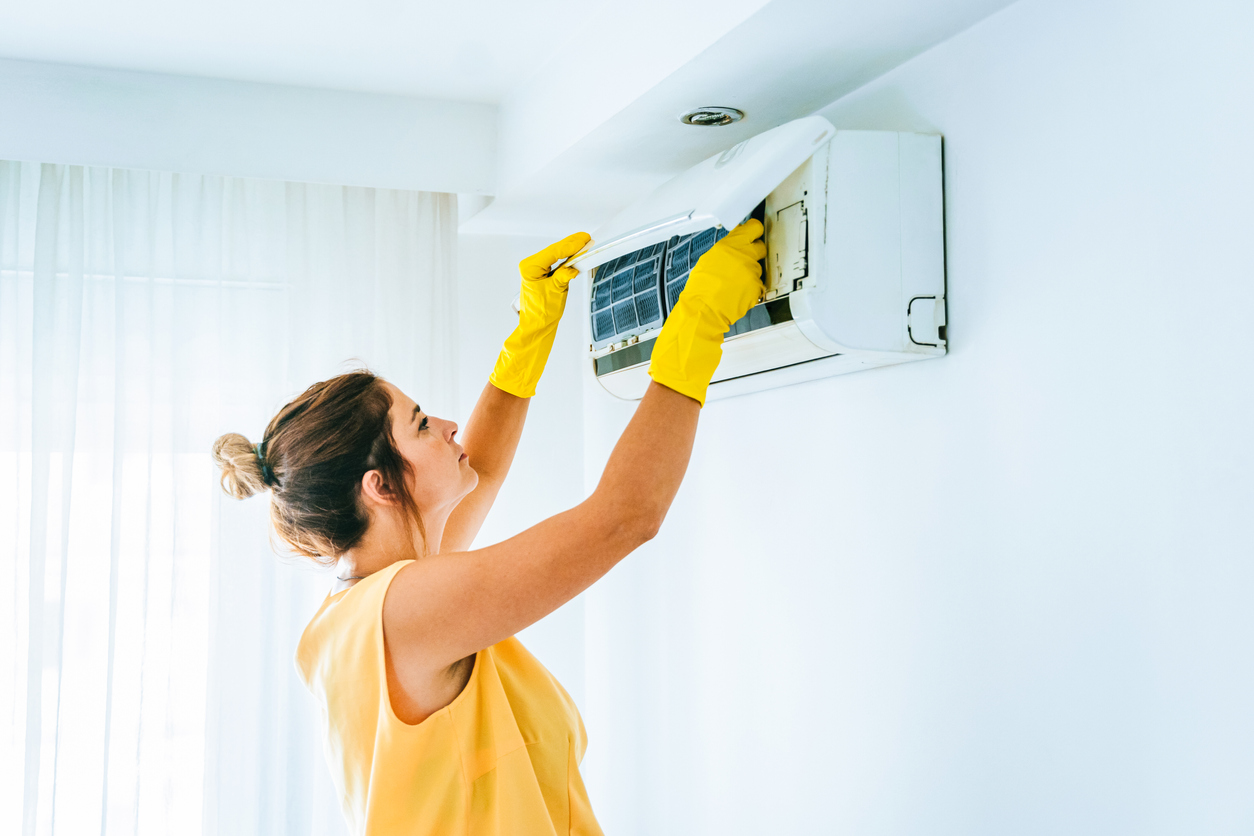iStock-1358089581 Bob Vila must do april products Woman Cleaning Air Conditioning System