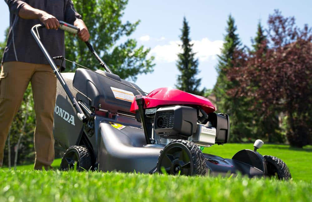 A close-up of the best mulching lawn mower option in use mowing a bright green lawn