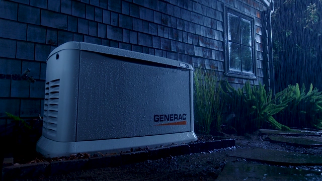 generac standby generator on dark rainy night
