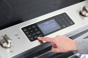 A stainless steel oven with a steam cleaning setting.
